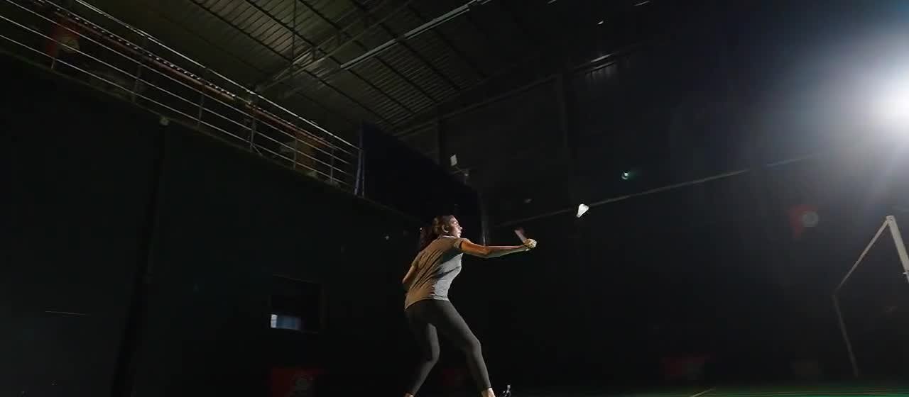 Badminton practice inside an indoor court